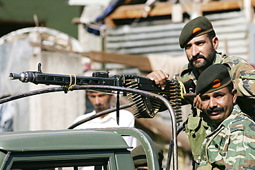 Armed Pakistani soldiers with machine gun  in village of Pattika, Pakistan