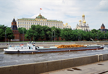 Cargo of logs passes The Kremlin and Moscow River, Russia