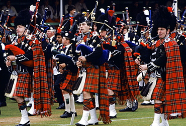 Traditional Scottish band in tartan kilts marching at the Braemar Royal Highland Gathering, the Braemar Games in Scotland