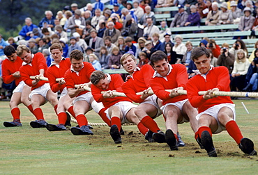 Scottish men taking part in traditional tug of war, tug o' war, at the Braemar Royal Highland Gathering, the Braemar Games in Scotland