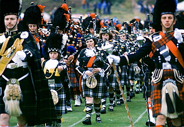 Traditional Scottish band in tartan kilts marching at the Braemar Royal Highland Gathering, the Braemar Games in Scotland