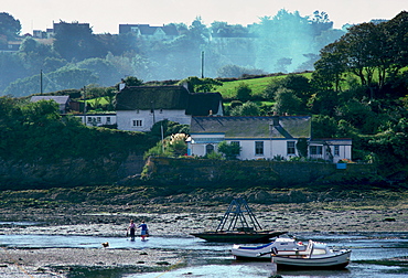 Two women and a dog at Gillan Harbour, Helford River Estuary, Cornwall, England