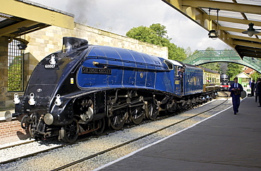 Sir Nigel Gresley A4 Pacific steam engine locomotive and train carriages at Pickering Railway station platform, Yorkshire, England, UK