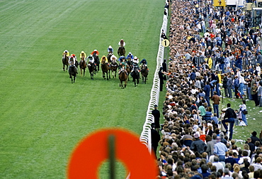 Crowds of spectactors by winning post at the racetrack at Epsom Racecourse for Derby Day, UK