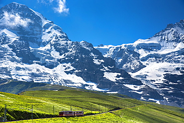 Jungfraubahn funicular train climbs to the Jungfrau from Kleine Scheidegg in the Swiss Alps in Bernese Oberland, Switzerland, Europe