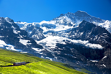 Jungfraubahn funicular train climbs to the Jungfrau from Kleine Scheidegg in the Swiss Alps in Bernese Oberland, Switzerland, Europe