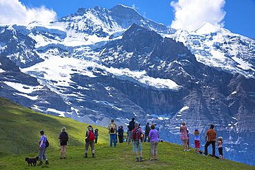 Tourists viewing the Jungfrau mountain peak in the Swiss Alps in Bernese Oberland, Switzerland, Europe