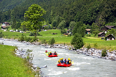 Tourists white water rafting towards Interlaken in the Bernese Oberland, Switzerland, Europe