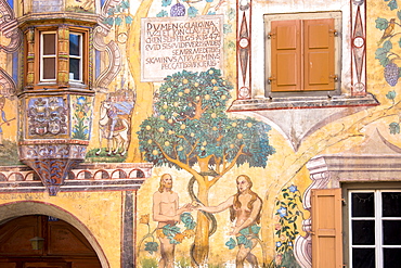 Adam and Eve mural and Romansch inscription painted on 17th century houses, village of Ardez, Engadine Valley, Graubunden, Switzerland, Europe