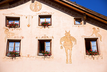 Windows in old painted stone 17th century building in the Engadine Valley in the village of Guarda, Graubunden, Switzerland, Europe