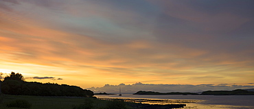 A solitary boat at sunset in Dunvegan Loch, a sea loch on the Isle of Skye, Western Isles, Inner Hebrides, Scotland, United Kingdom, Europe