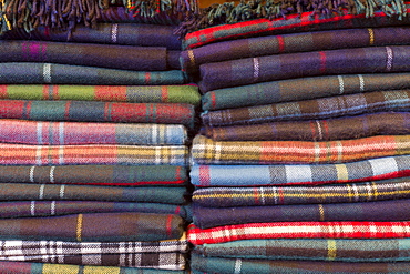 Traditional checks, plaid and Highland clan tartan lambswool throws and textiles on display for sale at Lochcarron Weavers at Lochcarron in the Highlands of Scotland, United Kingdom, Europe