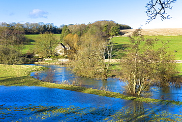 Flooded fields as the River Windrush burst its banks after heavy rain near Burford in The Cotswolds, Oxfordshire, England, United Kingdom, Europe