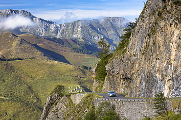 Motorist touring by car on empty road in the Pyrenees in Parc National des Pyrenees Occident, France, Europe