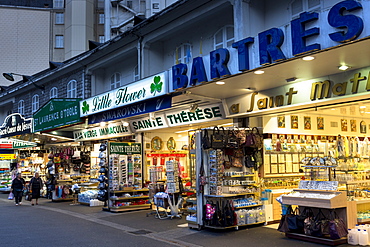 Religious icons and statues on sale at souvenir shops at pilgrimage location of Lourdes, Pyrenees, France, Europe