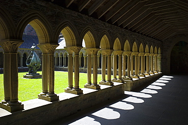 Cloisters and modern bronze sculpture Descent of the Spirit by Lithuanian artist Jacques Lipchitz at Iona Abbey, Isle of Iona, Inner Hebrides and Western Isles, Scotland, United Kingdom, Europe