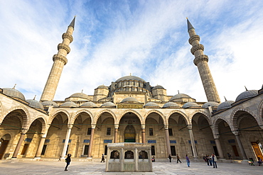 Tourists in colonnade courtyard of Suleymaniye Mosque, UNESCO World Heritage Site, Istanbul, Turkey, Europe