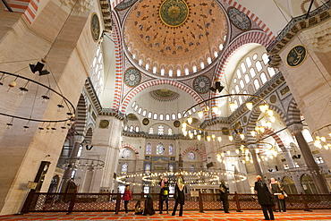 Tourists wearing scarves in Muslim tradition in interior of Suleymaniye Mosque, UNESCO World Heritage Site, Istanbul, Turkey, Europe