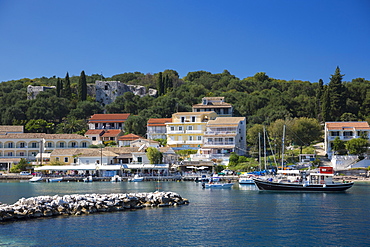 Spectacular beach resort and harbour of Kassiopi with blue sky and turquoise Ionian Sea, Corfu, Ionian Islands, Greek Islands, Greece, Europe