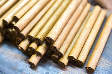 Stack of hand-rolled cigars of long leaf tobacco in traditional cigar factory, Decatur Street, New Orleans, USA