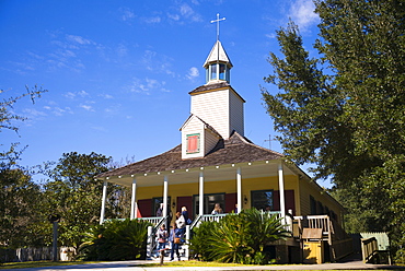 Tourists at Church at Vermilionville living history museum of Acadian (Cajun), Creole and Native American culture, Louisiana USA