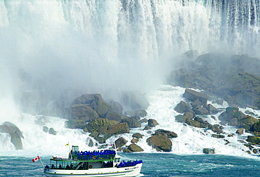 Tourists in waterproof capes on Maid of the Mist tourist boat at Niagara Falls,  Canada