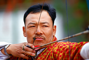 Archer taking aim during archery festival, Paro, Bhutan