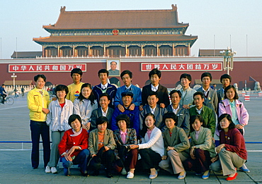 Chinese students posing for a group photograph in front of the Gate of Heavenly Peace entrance to the Forbidden City in Beijing, China