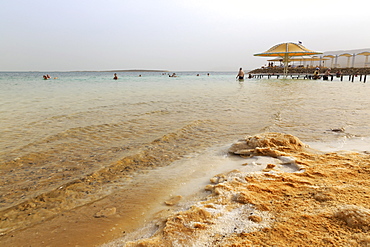 Bathers in the Dead Sea, with salty shoreline, Ein Bokek (En Boqeq) beach, Israel, Middle East