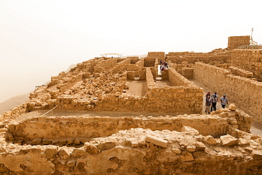 Tourists at Masada fortress ruins, air thick with desert sand, UNESCO World Heritage Site, Israel, Middle East