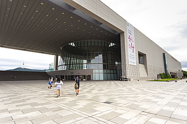 Visitors approach the Great Hall, National Museum of Korea, with distant N Seoul Tower, Yongsan-Gu, Seoul, South Korea, Asia