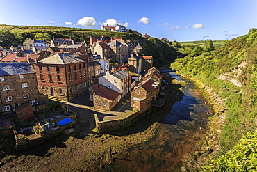 Steep streets of fishing village nd river, elevated view in summer, Staithes, North Yorkshire Moors National Park, Yorkshire, England, United Kingdom, Europe