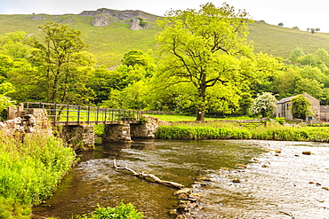 Bridge across River Wye, stone farm buildings, Monsal Dale, spectacular limestone scenery, Peak District, Derbyshire, England, United Kingdom, Europe