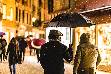 People in shopping street with umbrellas during rare snowfall, winter evening, Venice, UNESCO World Heritage Site, Veneto, Italy, Europe