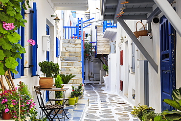 Narrow street, whitewashed buildings with blue paint work, flowers, Mykonos Town (Chora), Mykonos, Cyclades, Greek Islands, Greece, Europe