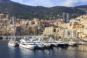 Pastel hues of the glamorous harbour of Monaco (Port Hercules) with many yachts, view from the sea, Monte Carlo, Monaco, Cote d'Azur, Mediterranean, Europe