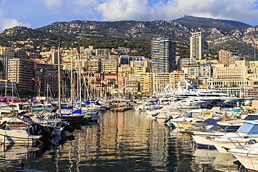 Vivid hues of the glamorous harbour of Monaco (Port Hercules) with many yachts and reflections, Monte Carlo, Monaco, Cote d'Azur, Mediterranean, Europe