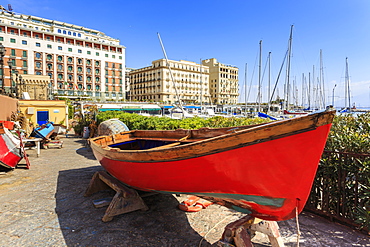 Colourful rowing boats under repair at the marina Borgo Marinaro, with backdrop of grand hotels, Chiaia, City of Naples, Campania, Italy, Europe