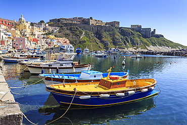 Marina Corricella, pretty fishing village, colourful houses, boats and Terra Murata, Procida Island, Bay of Naples, Campania, Italy, Europe