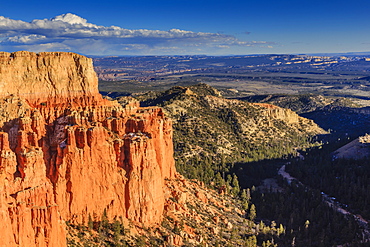 Rim cliffs and hoodoos lit by late afternoon sun with distant view in winter, Paria View, Bryce Canyon National Park, Utah, United States of America, North America