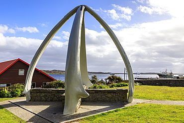 Restored Whalebone Arch, ships and the Narrows waterfront, Stanley Harbour, Port Stanley, Falkland Islands, South America