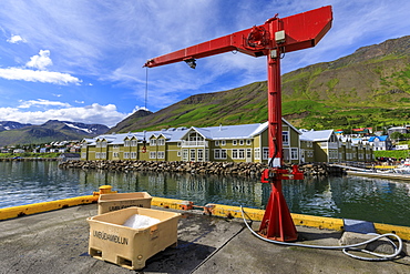 Fishing crates and equipment on quay, mountains and town, Siglufjordur, (Siglufjorour), stunning Summer weather, North Iceland, Europe