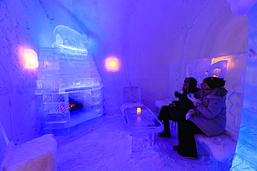 Sorrisniva Igloo Hotel, ice hotel, striking sculpture, cosy fire in ice bar in winter, Alta, Finnmark, Arctic Circle, Norway, Scandinavia, Europe