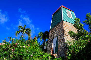 Swedish Bell Tower, palm trees and flowering shrubs, Gustavia, St. Barthelemy (St. Barts) (St. Barth), West Indies, Caribbean, Central America