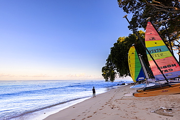 Paynes Bay at sunrise, lady exercises on beach, colourful sail boats, beautiful West Coast, Barbados, Windward Islands, West Indies, Caribbean, Central America