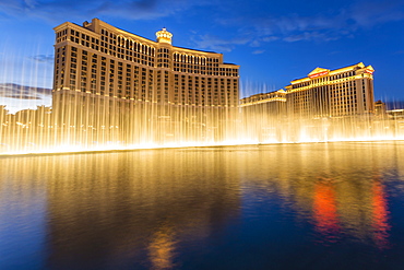 Bellagio and Caesars Palace reflections at dusk with fountains, The Strip, Las Vegas, Nevada, United States of America, North America 