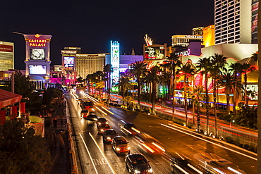 Neon lights, Las Vegas Strip at night with cars leaving light streaks in front of Caesars, Mirage and Flamingo, Las Vegas, Nevada, United States of America, North America 