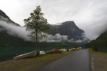 Rowing boats, lake, mountains and low cloud, Lovatnet Lake, Norway, Scandinavia, Europe 