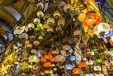 Many hanging and lit colourful and decorative Turkish glass light shades in a shop, Grand Bazaar, Istanbul, Turkey, Europe