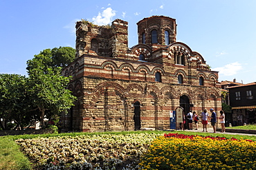 Flower border and visitors, Church of Christ Pantokrator, Nesebar (Nessebar), UNESCO World Heritage Site, Black Sea Coast, Bulgaria, Europe